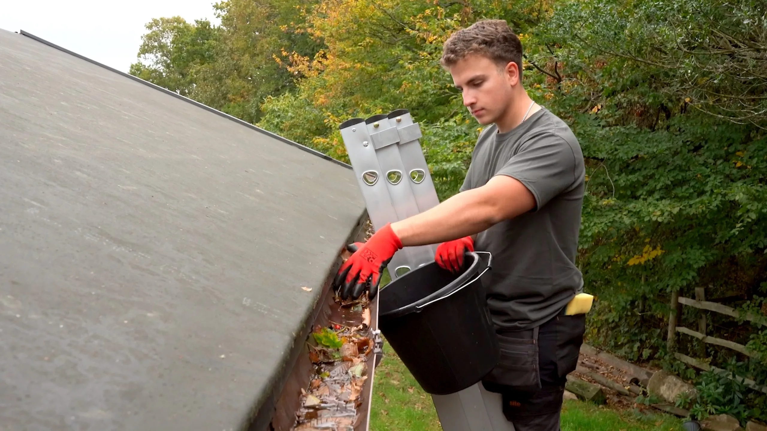 Bristol gutter cleaning technician removing debris from a blocked gutter